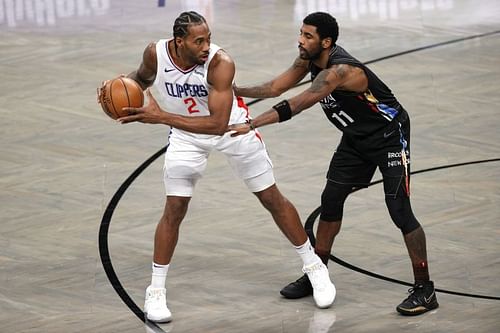 Kawhi Leonard #2 of the LA Clippers dribbles against Kyrie Irving #11 of the Brooklyn Nets