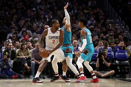 Kawhi Leonard #2 of the LA Clippers looks to pass the ball against Dillon Brooks #24 and Ja Morant #12 of the Memphis Grizzlies 