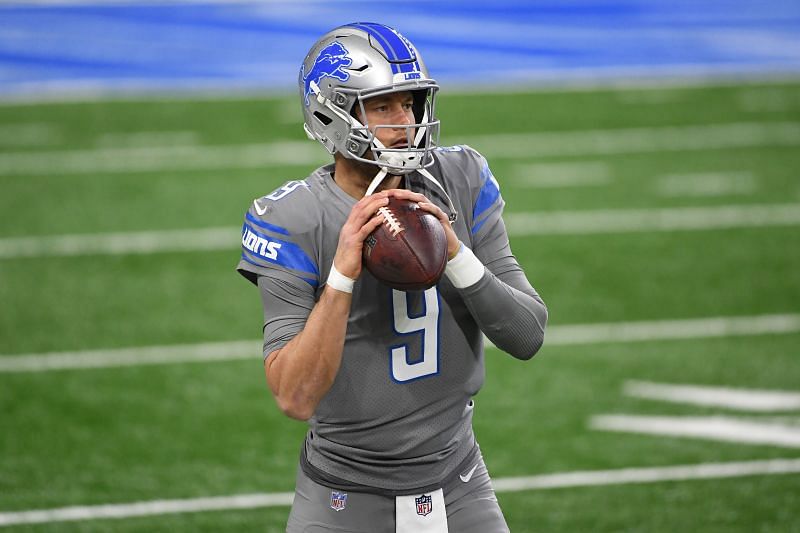 Georgia quarterback Matthew Stafford holds up his Detroit Lions