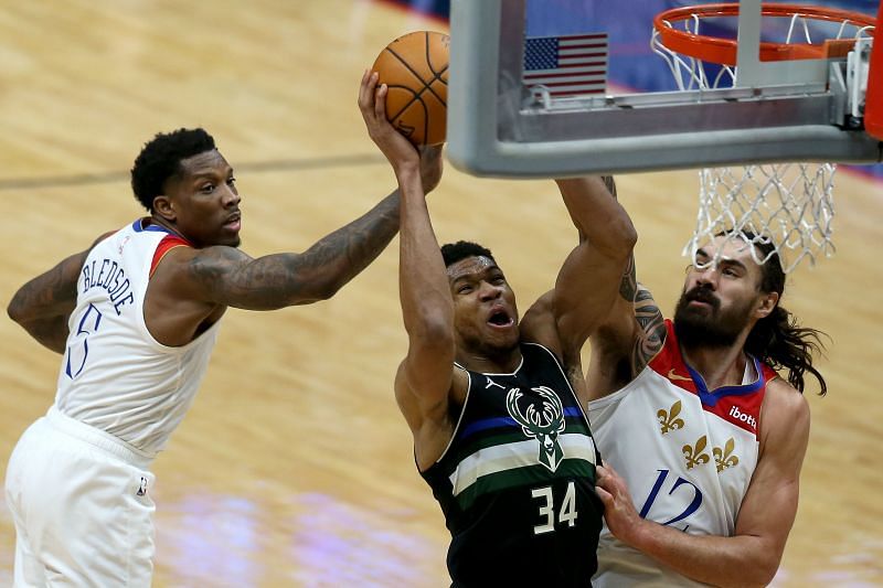 Giannis Antetokounmpo of the Milwaukee Bucks shoots against Eric Bledsoe and Steven Adams of the New Orleans Pelicans (Photo by Sean Gardner/Getty Images)