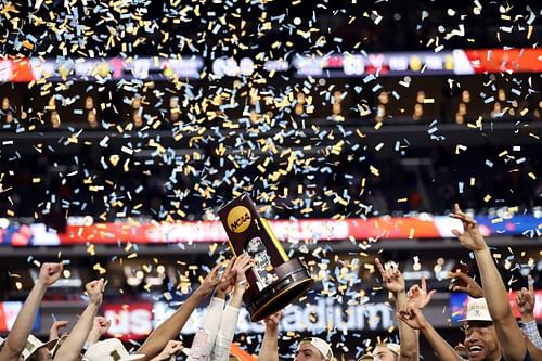 The Virginia Cavaliers celebrate with the NCAA March Madness trophy after their teams win in the 2019 NCAA men's Final Four National Championship game.