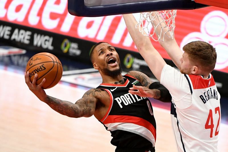 Damian Lillard of the Portland Trail Blazers drives to the basket against Davis Bertans of the Washington Wizards.