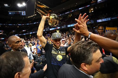 Stephen Curry #30 of the Golden State Warriors celebrates with the Larry O'Brien Trophy.