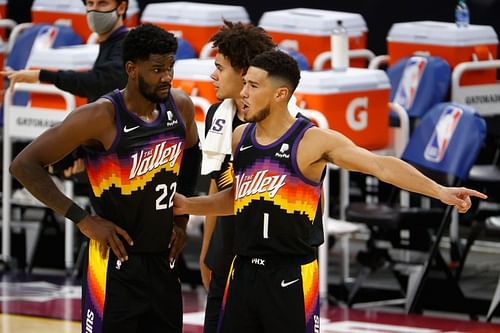 Devin Booker of the Phoenix Suns talks with Deandre Ayton.