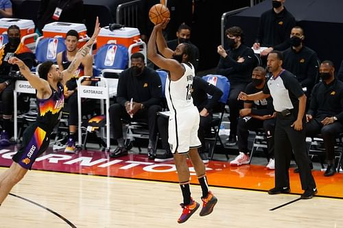 James Harden #13 of the Brooklyn Nets attempts a three-point shot over Abdel Nader #11 of the Phoenix Suns during the second half of the NBA game at Phoenix Suns Arena on February 16, 2021 (Photo by Christian Petersen/Getty Images)