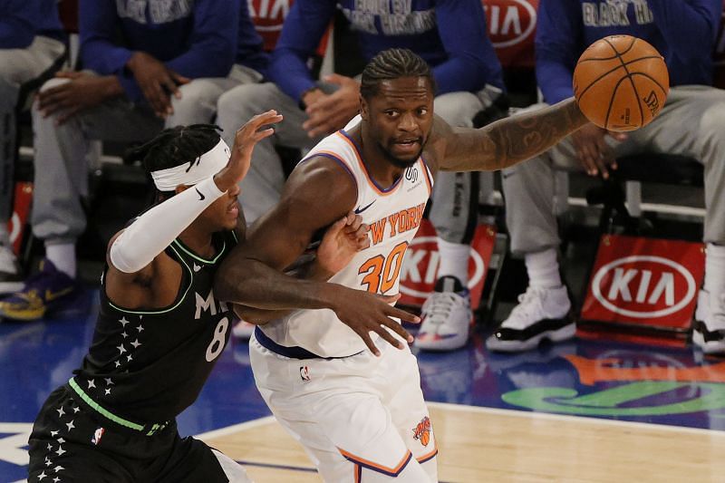 Julius Randle of the New York Knicks dribbles against Jarred Vanderbilt of the Minnesota Timberwolves