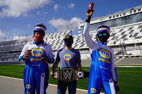 The Street Profits presenting the WWE Championship to NASCAR driver, Chase Elliott.