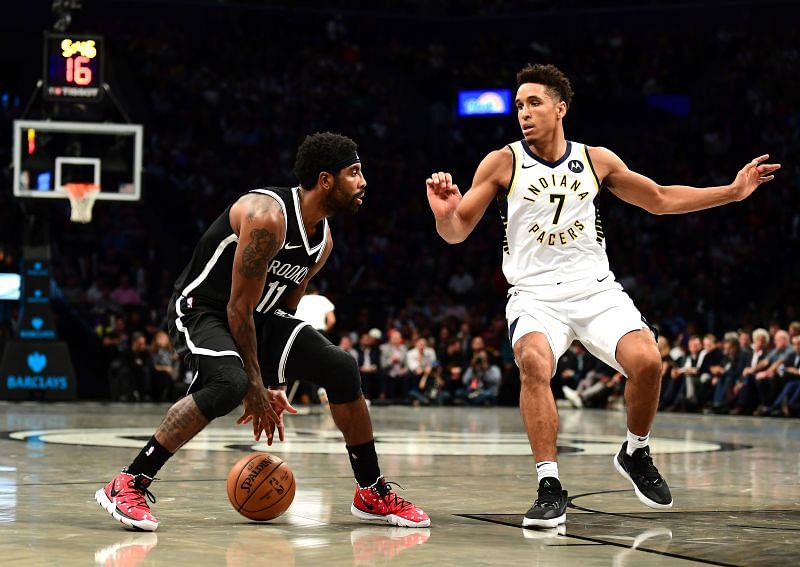 Kyrie Irving #11 of the Brooklyn Nets dribbles the ball as Malcolm Brogdon #7 of the Indiana Pacers