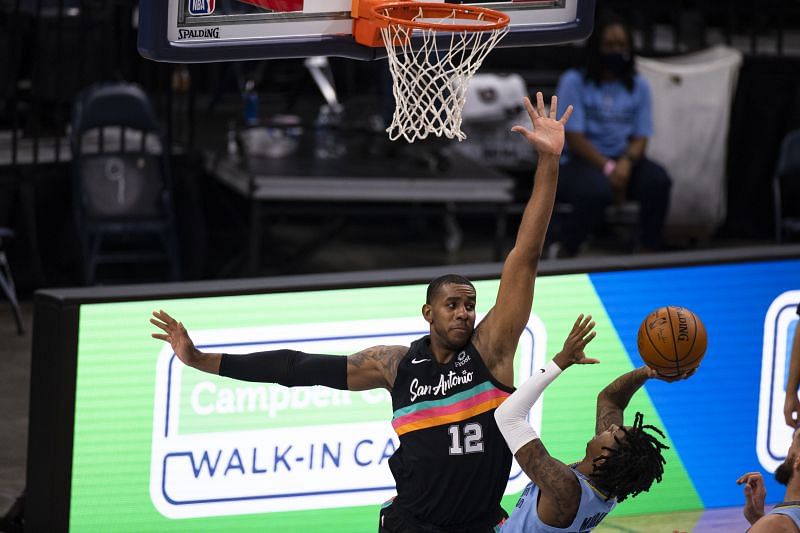 LaMarcus Aldridge #12 of the San Antonio Spurs defends as Ja Morant #12 of the Memphis Grizzlies shoots the ball.