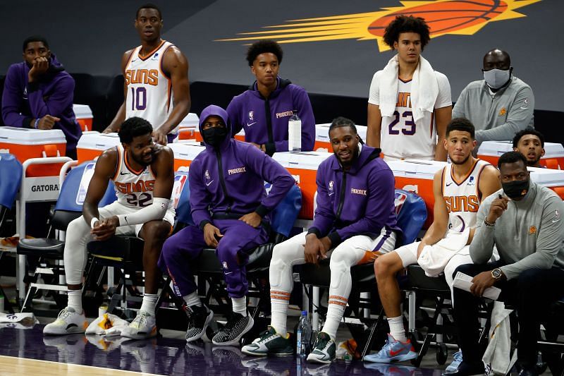 Deandre Ayton, Chris Paul, Jae Crowder, and Devin Booker of the Phoenix Suns watch from the bench during the second half of the NBA preseason game against the Los Angeles Lakers.