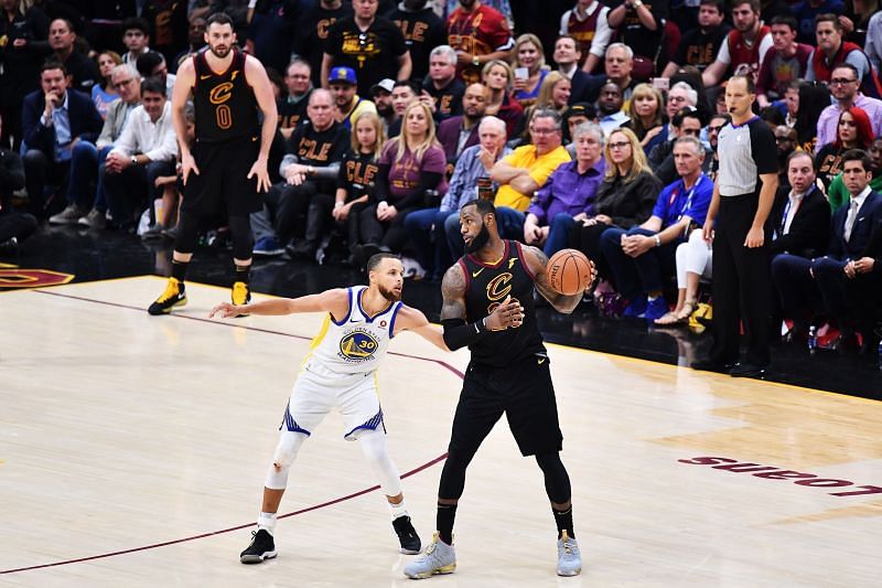 LeBron James #23 of the Cleveland Cavaliers controls the ball against Stephen Curry #30 of the Golden State Warriors during the 2018 NBA Finals.