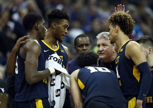 Head coach Bob Huggins of the West Virginia Mountaineers talks with players during a timeout