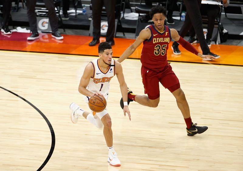 Devin Booker #1 of the Phoenix Suns handles the ball against Isaac Okoro #35 of the Cleveland Cavaliers