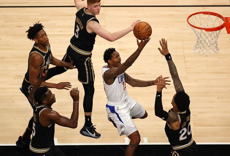 Lou Williams of the LA Clippers drives against John Collins, Clint Capela, De&#039;Andre Hunter and Kevin Huerter of the Atlanta Hawks (Photo by Kevin C. Cox/Getty Images)