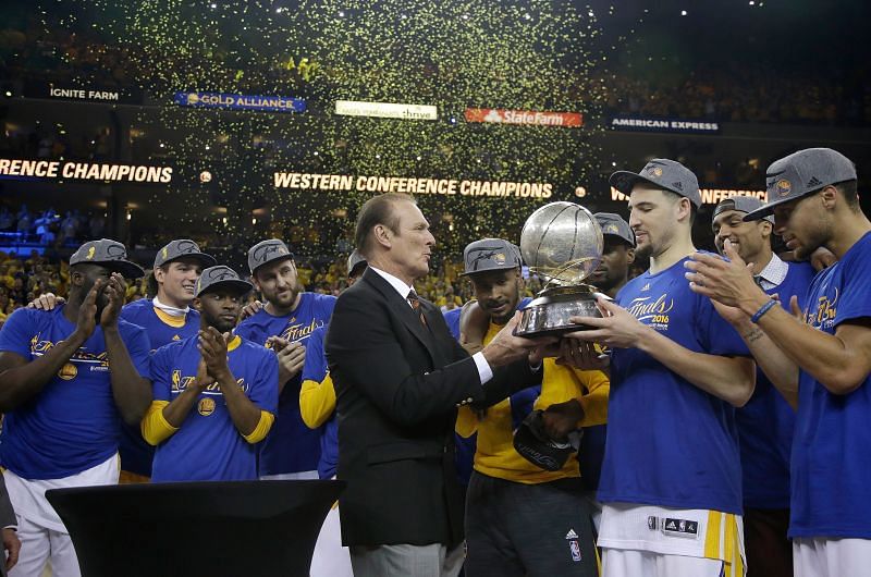 Klay Thompson #11 of the Golden State Warriors is presented the Western Conference Championship Trophy by former NBA player Rick Barry in 2016