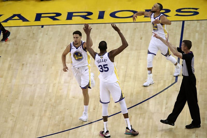 Klay Thompson (#11 )of the Golden State Warriors celebrates with Kevin Durant (#35) and Stephen Curry (#30) against the Cleveland Cavaliers in Game 1 of the 2018 NBA Finals.