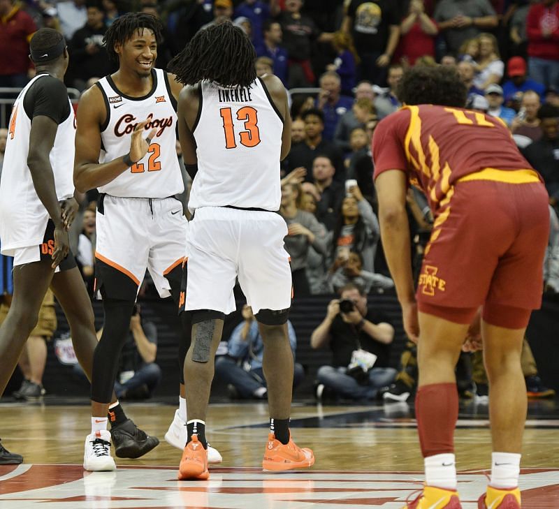 Kalib Boone and Isaac Likekele of the Oklahoma State Cowboys celebrate their win over the Iowa State Cyclones.