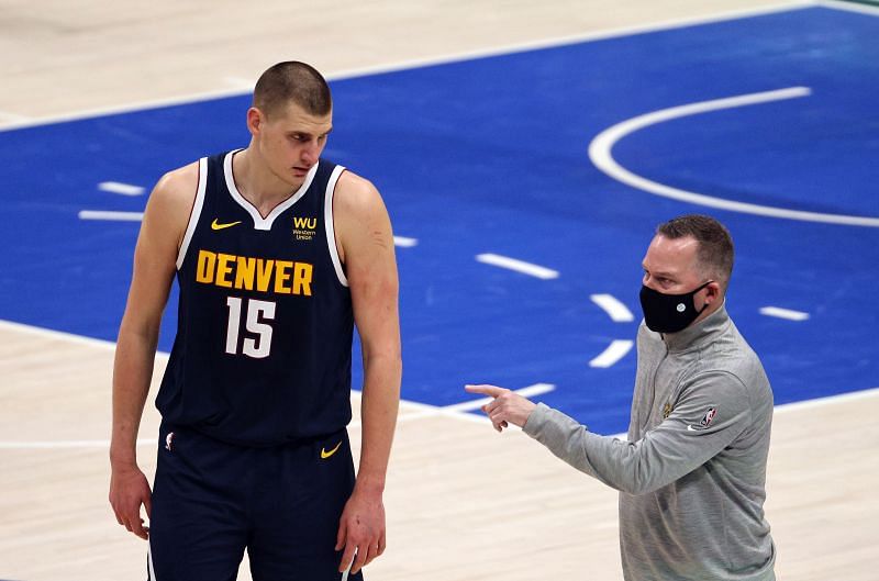 Nikola Jokic of the Denver Nuggets during an interaction with head coach Mike Malone