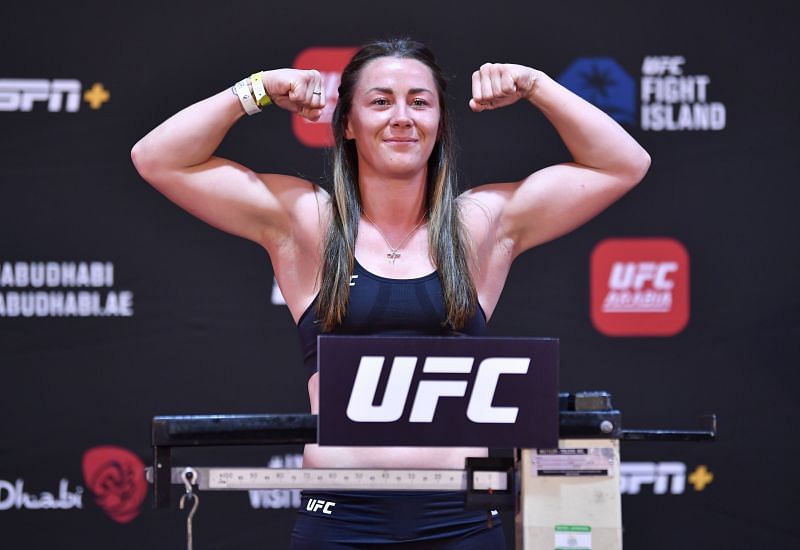 Molly McCann left gloves inside the UFC octagon following her decision loss to Lara Procopio