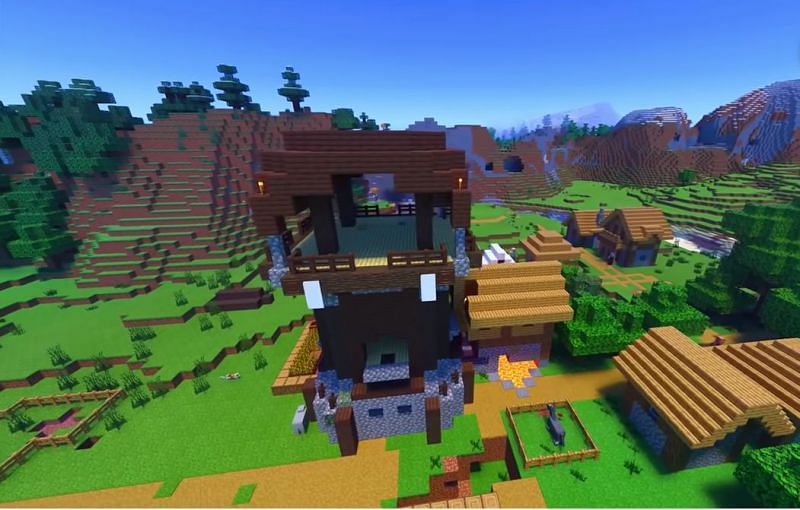 A Pillager outpost right in the middle of a village in Minecraft (Image via Minecraft &amp; Chill/YouTube)