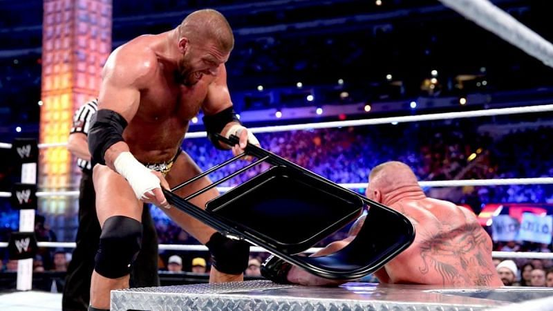 Triple H landing chair shots to Brock Lesnar at WrestleMania 29 in 2013