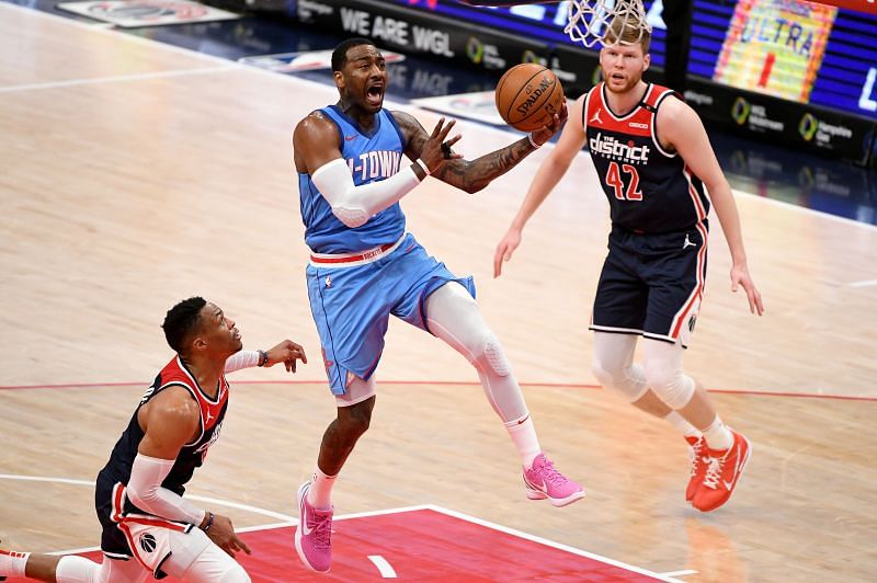 John Wall #1 of the Houston Rockets shoots in front of Russell Westbrook #4 of the Washington Wizards