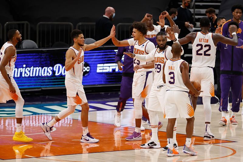 Devin Booker of the Phoenix Suns celebrates with Mikal Bridges, Jae Crowder, Deandre Ayton and Chris Paul after defeating the Dallas Mavericks in an NBA game (Photo by Christian Petersen/Getty Images)