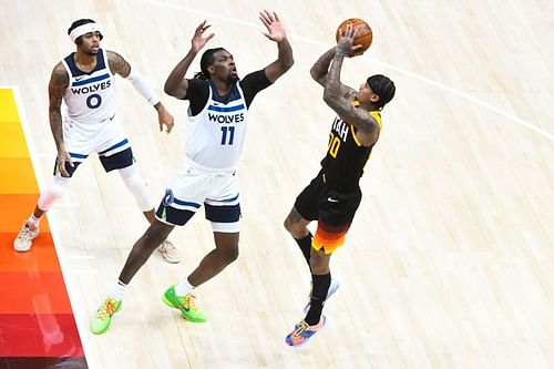 Jordan Clarkson #00 of the Utah Jazz shoots over Naz Reid #11 of the Minnesota Timberwolves during a game at Vivint Smart Home Arena on December 26, 2020 in Salt Lake City, Utah.