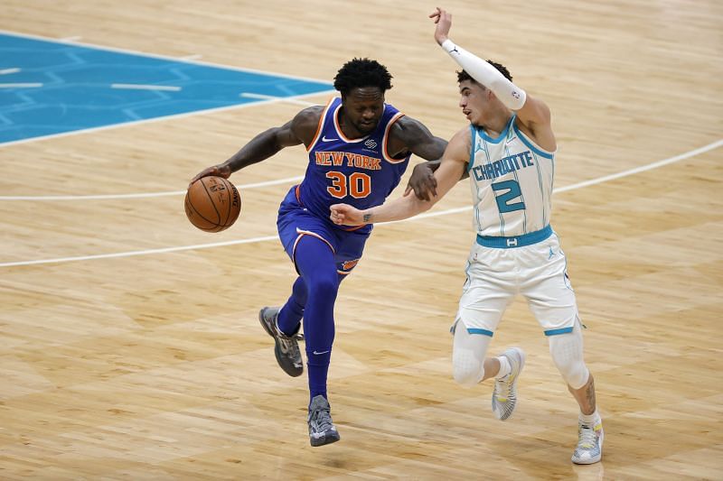 Julius Randle #30 of the New York Knicks brings the ball up court against LaMelo Ball #2 of the Charlotte Hornets during the first quarter of their game at Spectrum Center on January 11, 2021 in Charlotte, North Carolina.