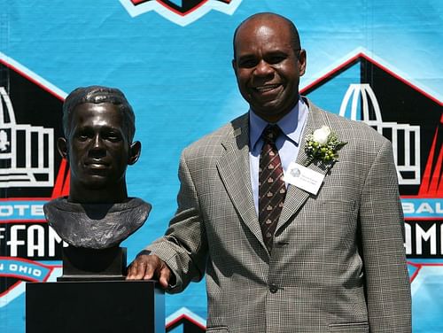 Pollard's Grandson stand next to Fritz Pollard's bust