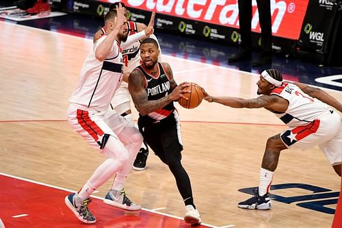 Damian Lillard of the Portland Trail Blazers goes up against Bradley Beal of the Washington Wizards