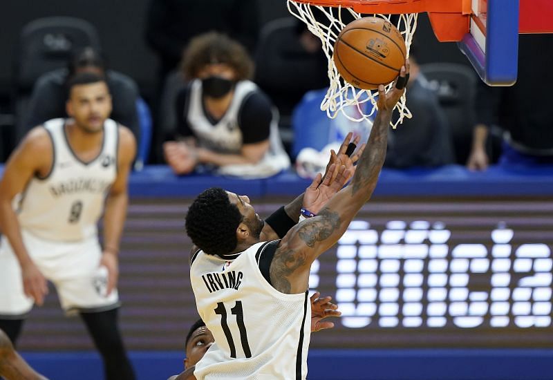 Kyrie Irving #11 of the Brooklyn Nets goes in for a layup against the Golden State Warriors