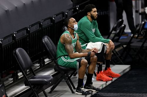 Jeff Teague #55 and Jayson Tatum #0 of the Boston Celtics sit in the cool down area