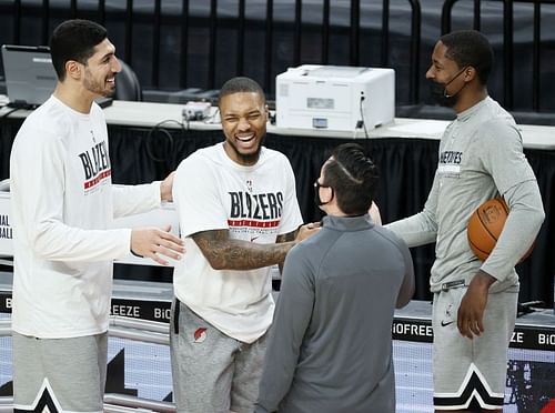 Enes Kanter #11 and Damian Lillard #0 of the Portland Trail Blazers greet Minnesota Timberwolves staff before the game at Moda Center on January 07, 2021 (Photo by Steph Chambers/Getty Images)