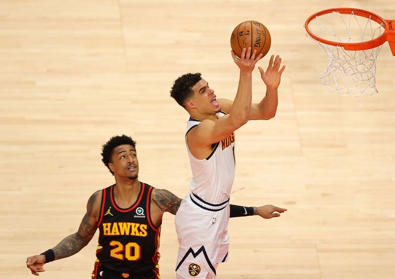 Michael Porter Jr. #1 of the Denver Nuggets draws a foul as he attacks the basket against John Collins #20 of the Atlanta Hawks.