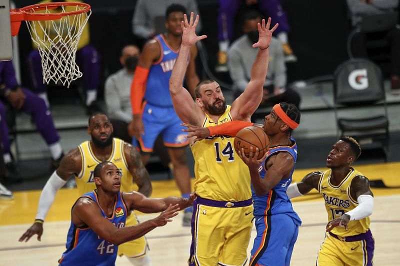 Marc Gasol #14 of the Los Angeles Lakers defends against Shai Gilgeous-Alexander #2 of the Oklahoma City Thunder.