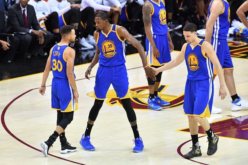 Stephen Curry (#30), Kevin Durant (#35) and Klay Thompson (#11) of the Golden State Warriors.