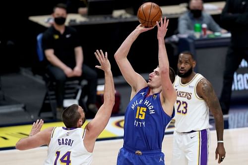 Nikola Jokic #15 of the Denver Nuggets puts up a shot over Marc Gasol #14 of the Los Angeles Lakers in the first quarter at Ball Arena on February 14, 2021 in Denver, Colorado. (Photo by Matthew Stockman/Getty Images)