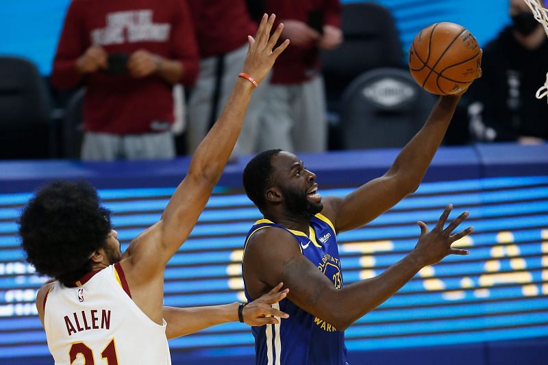 Draymond Green #23 of the Golden State Warriors goes to the basket against Jarrett Allen #31 of the Cleveland Cavaliers.