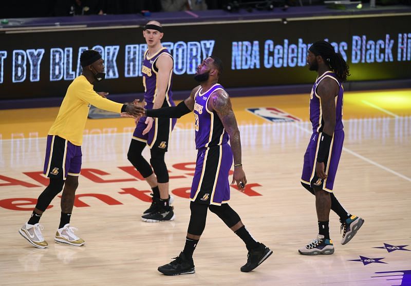 LeBron James #23 of the Los Angeles Lakers celebrates the end of the first half with Dennis Schroder #17 as Alex Caruso #4 and Montrezl Harrell #15 of the Los Angeles Lakers leave the court. (Photo by Harry How/Getty Images)