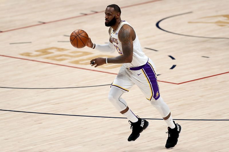 LeBron James #23 of the Los Angeles Lakers advances the ball against the Denver Nuggets in the third quarter at Ball Arena on February 14, 2021 in Denver, Colorado. (Photo by Matthew Stockman/Getty Images)