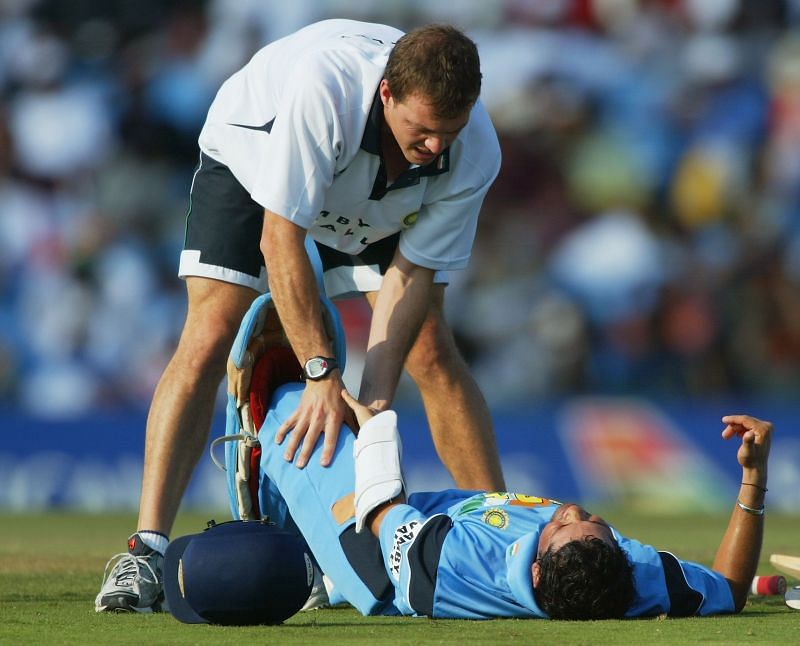 Physio Andrew Leipus gave Sachin Tendulkar a rehydrating drink and stretched his hamstring.