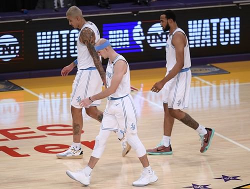 Kyle Kuzma #0, Alex Caruso #4, and Talen Horton-Tucker #5 react as they leave the floor after a timeout. (Photo by Harry How/Getty Images)