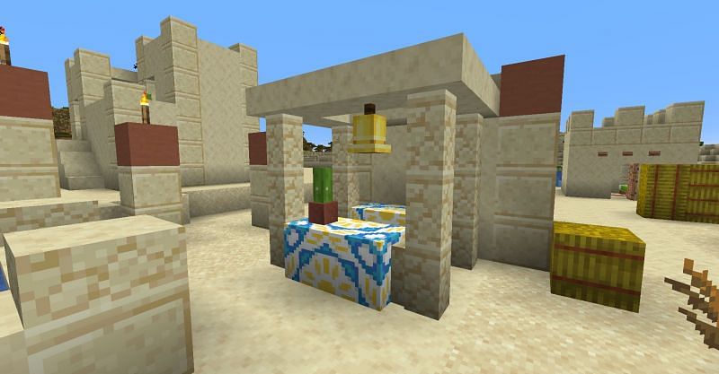 A bell in the middle of a desert village in Minecraft. (Image via Minecraft)