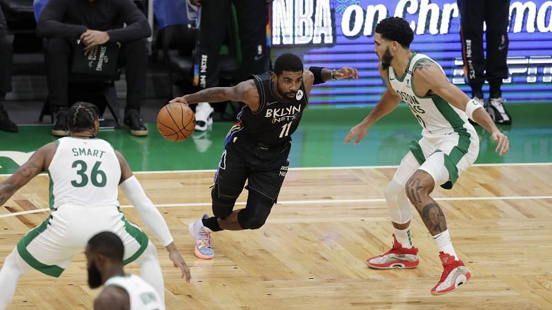 Kyrie Irving, #(11) of the Brooklyn Nets, drives to the basket in a game against the Boston Celtics.