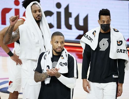 Carmelo Anthony #00, Damian Lillard #0, and CJ McCollum #3 of the Portland Trail Blazers react after defeating Minnesota Timberwolves 