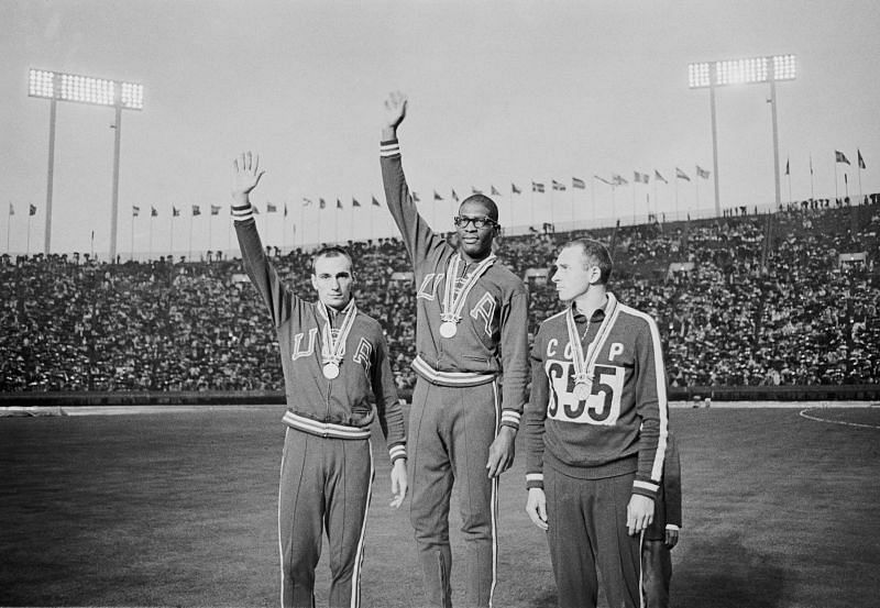 Hayes Jones (centre) celebrates his gold medal after winning the Men&#039;s 110 metres Hurdles during the 1964 Summer Olympic Games in Tokyo, Japan