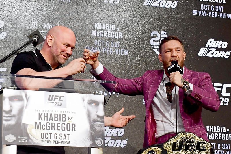 Conor McGregor serves UFC president Dana White a glass of his whiskey Proper No. Twelve