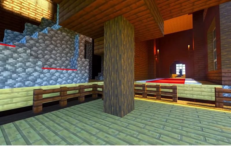 A pillager outpost that has clipped with the corner of a woodland mansion in Minecraft (Image via Minecraft &amp; Chill/YouTube)