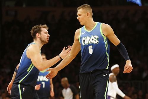 Luka Doncic #77 and Kristaps Porzingis #6 high-five during the second half against the Los Angeles Lakers 